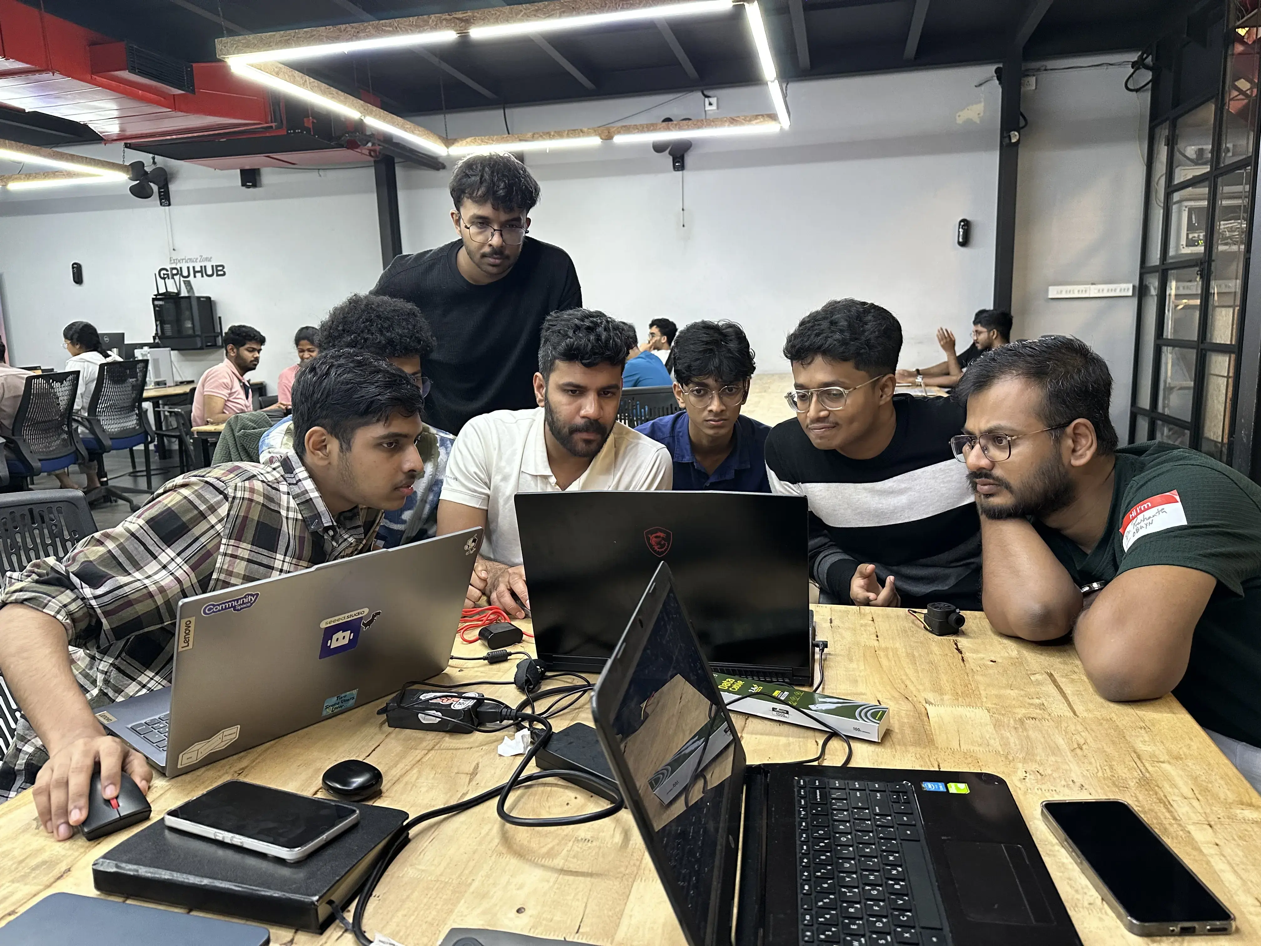 Learners collaborating around laptops at TinkerHub
