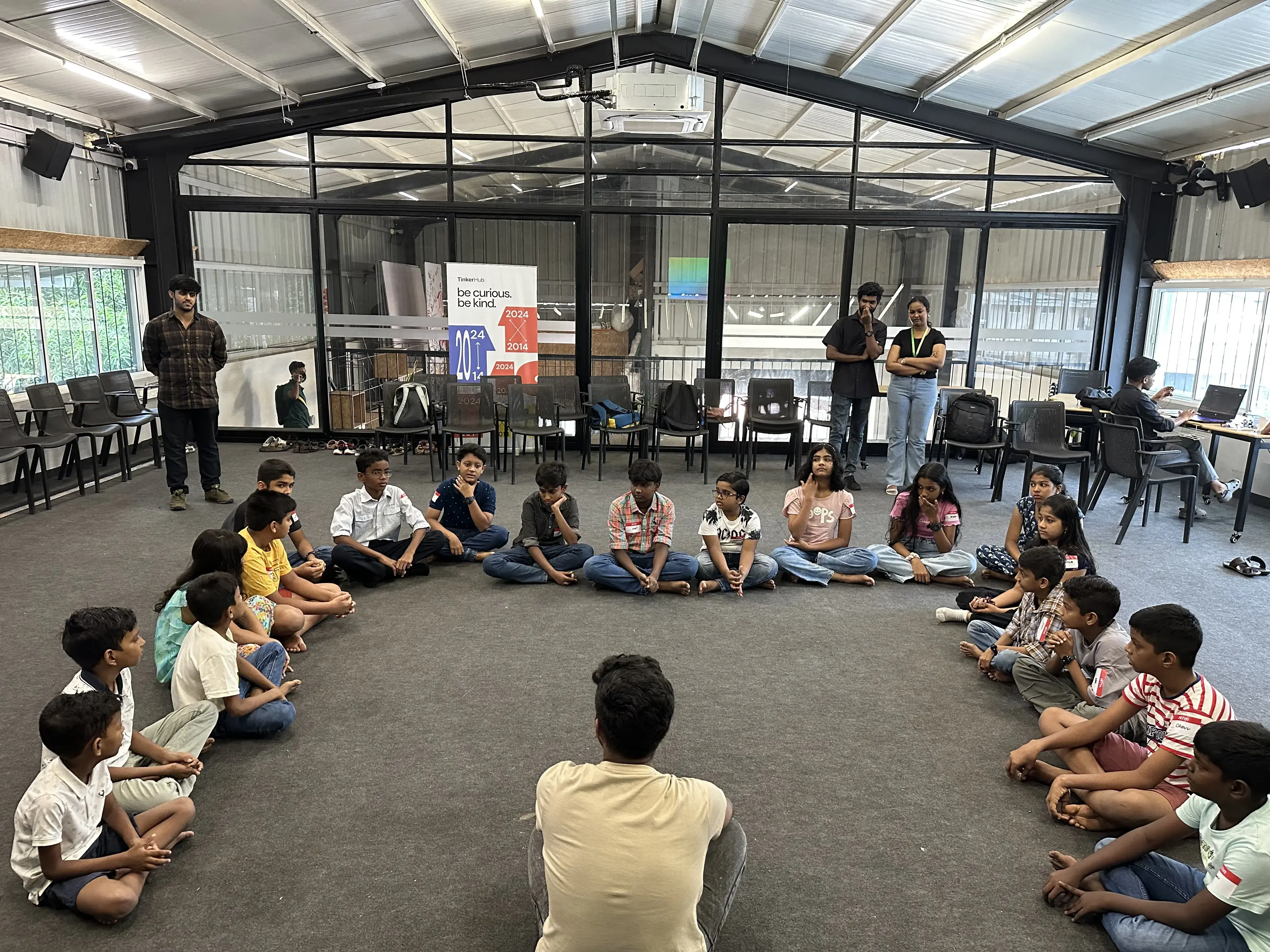 Children seated in a learning circle at TinkerHub